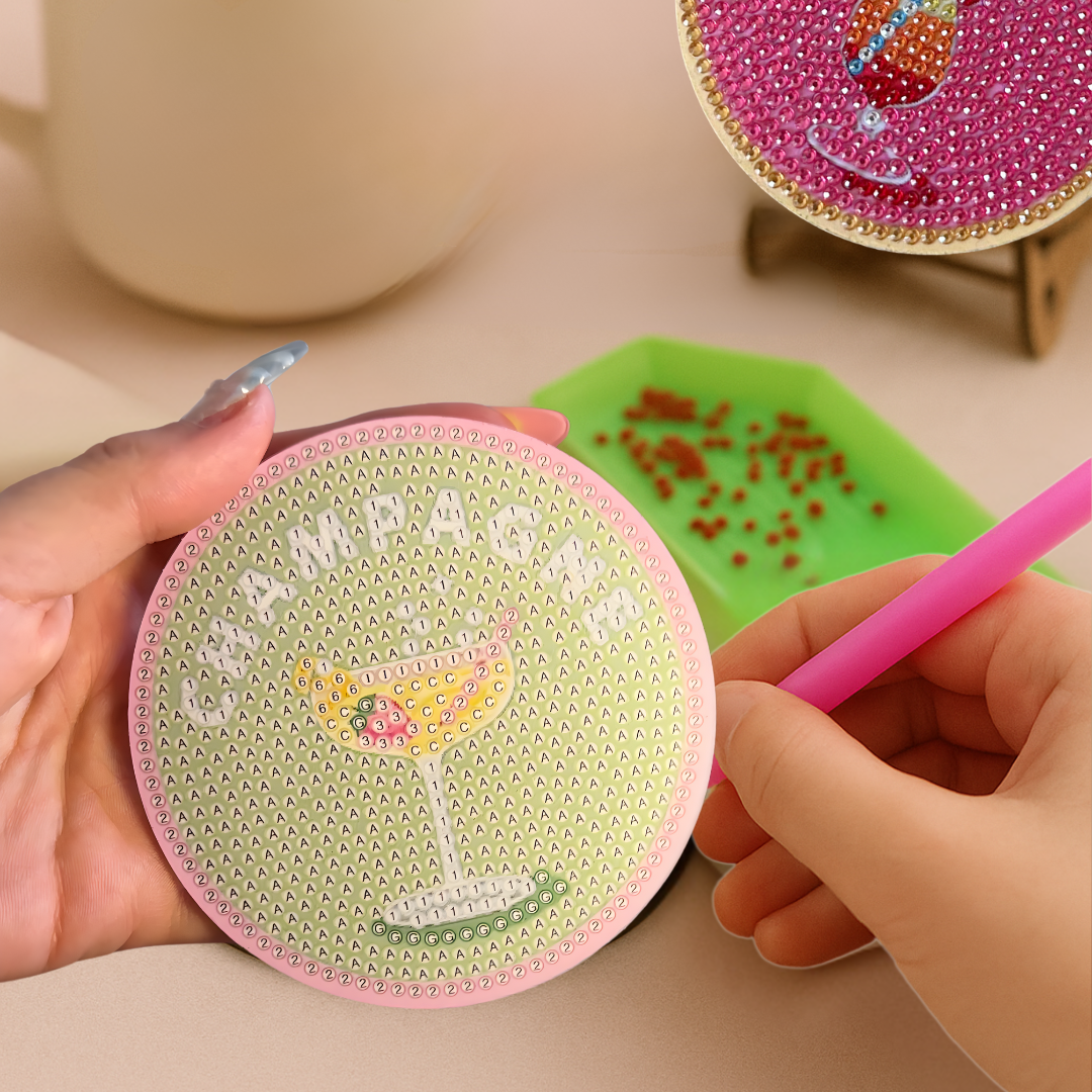 Coasters with 'Tequila' and 'Pampers' designs, one being held by a hand with a pen.